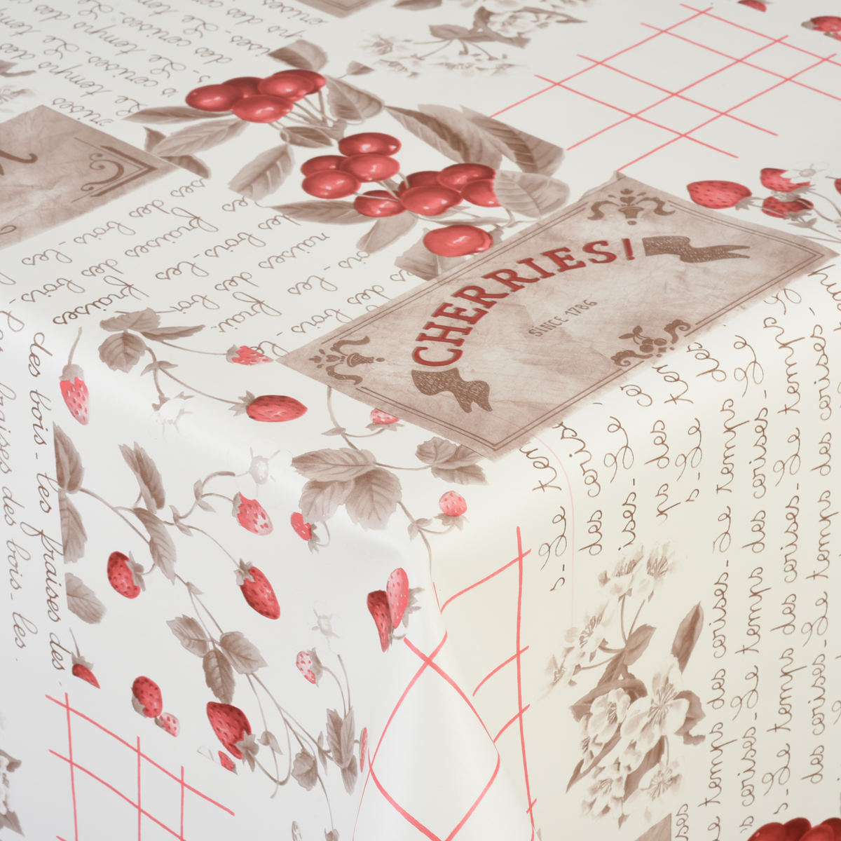 Wachstischdecke Premium Fruits aus glänzendem Wachstuch mit Erdbeer-, Beeren- und Schriftmuster in Creme und Rot